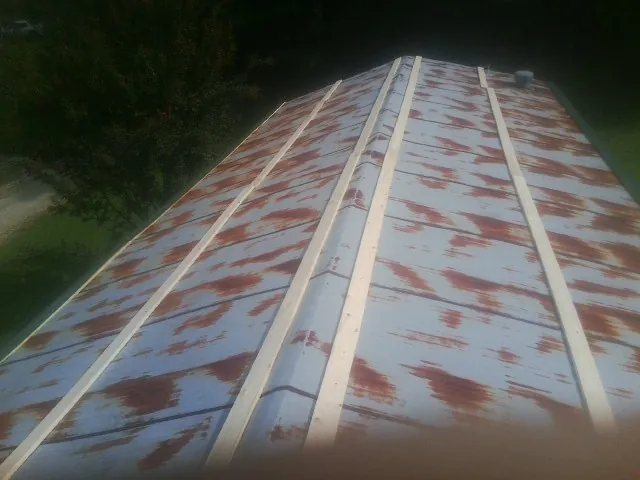 Rusted metal roof panels with new wood purlins before replacement — Storm Damage Roof Repair in Kimberly by Roofing Brothers