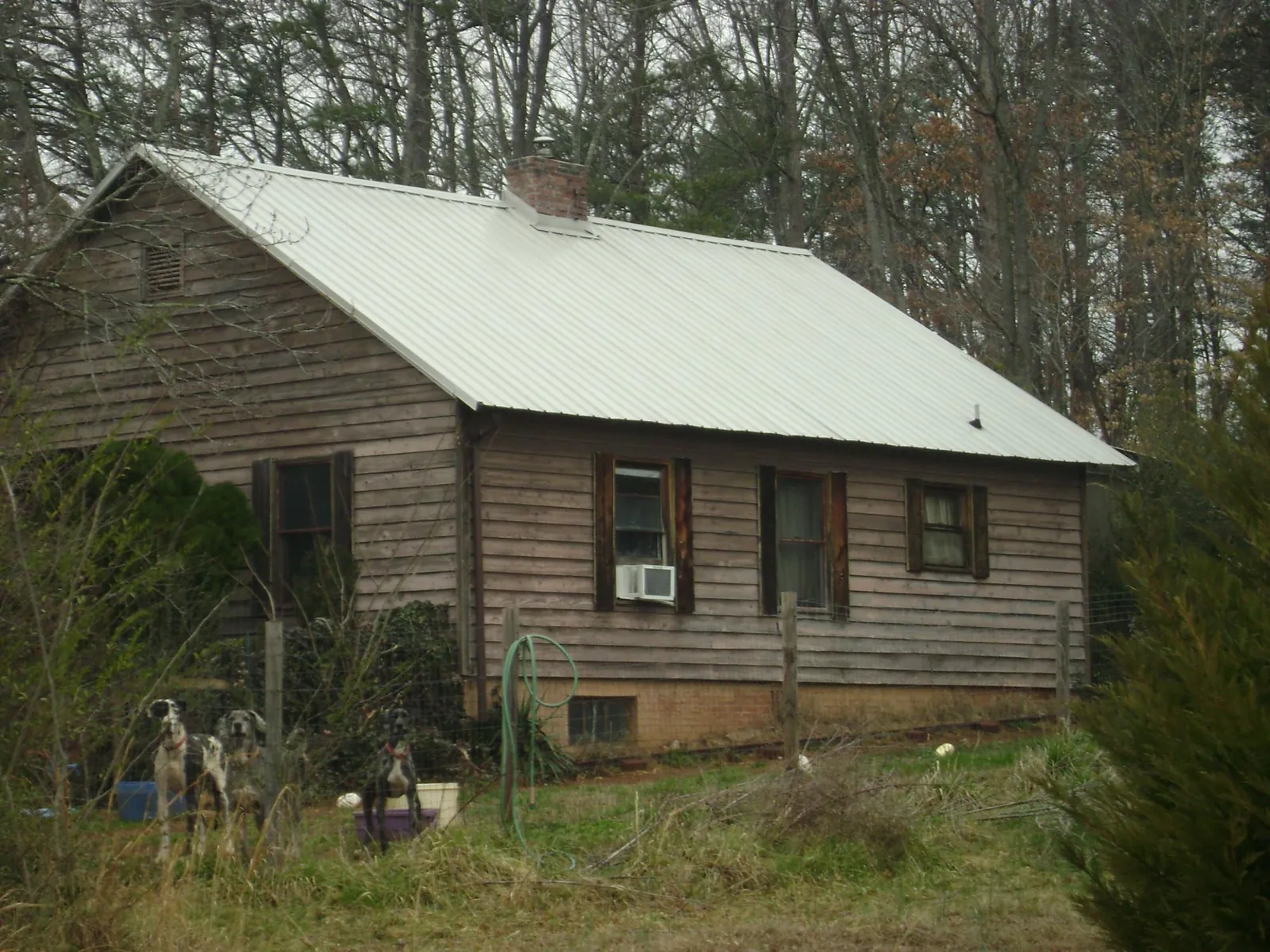 White metal roof on an old wood sided farmhouse, from a Metal Roof Installation job in Kimberly